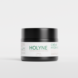 Pot de crème hydratante HOLYNE Crème Hydra+, avec des indications de cure dermatologique spécialisée, sur un fond blanc épuré.